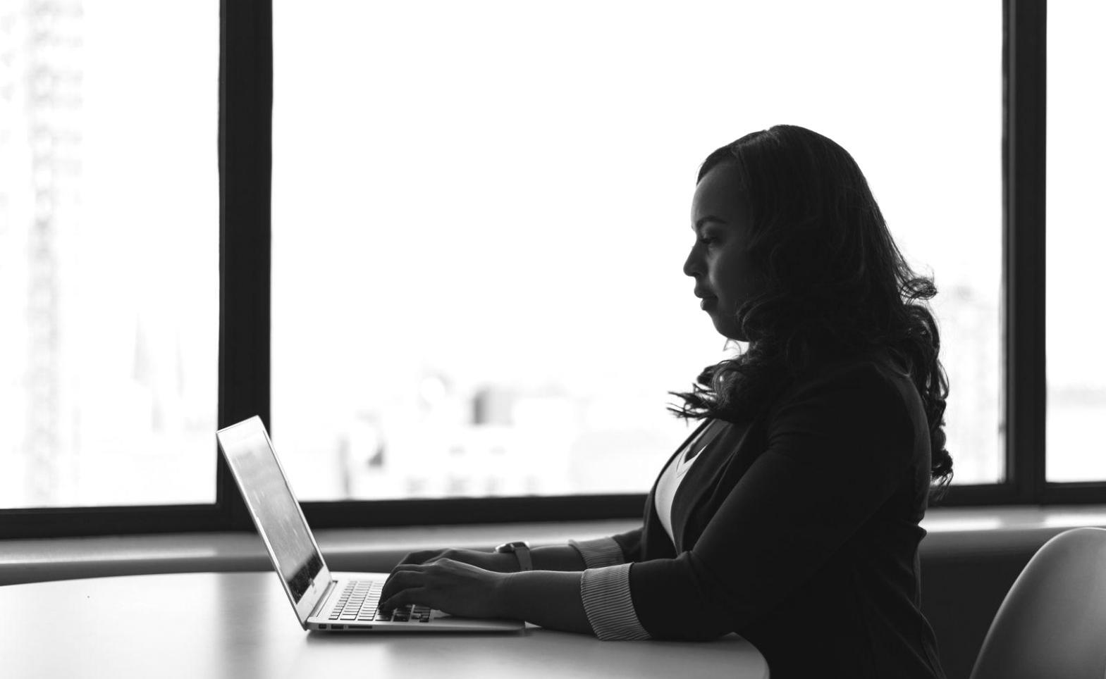 Professional trading workspace with multiple monitors displaying market charts and technical analysis indicators